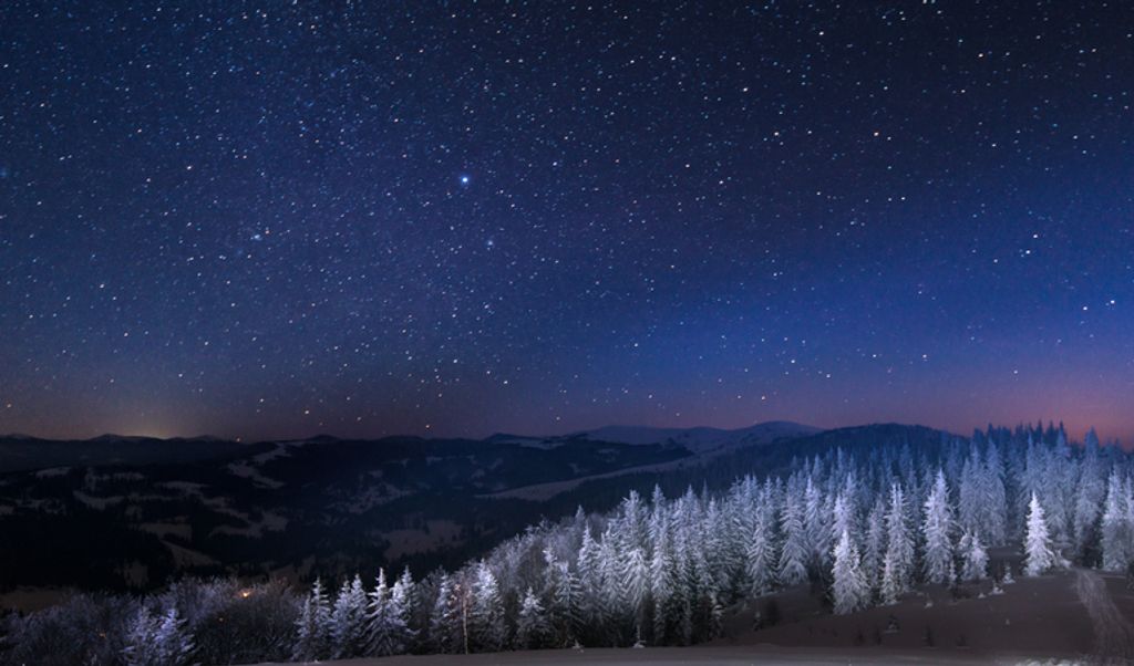 Snowy view of the January night sky over snowy Carpathian Mountains