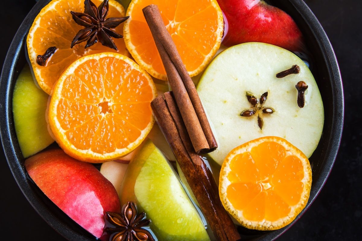 Simmering Pot with cinnamon sticks, fruit slices, and spices